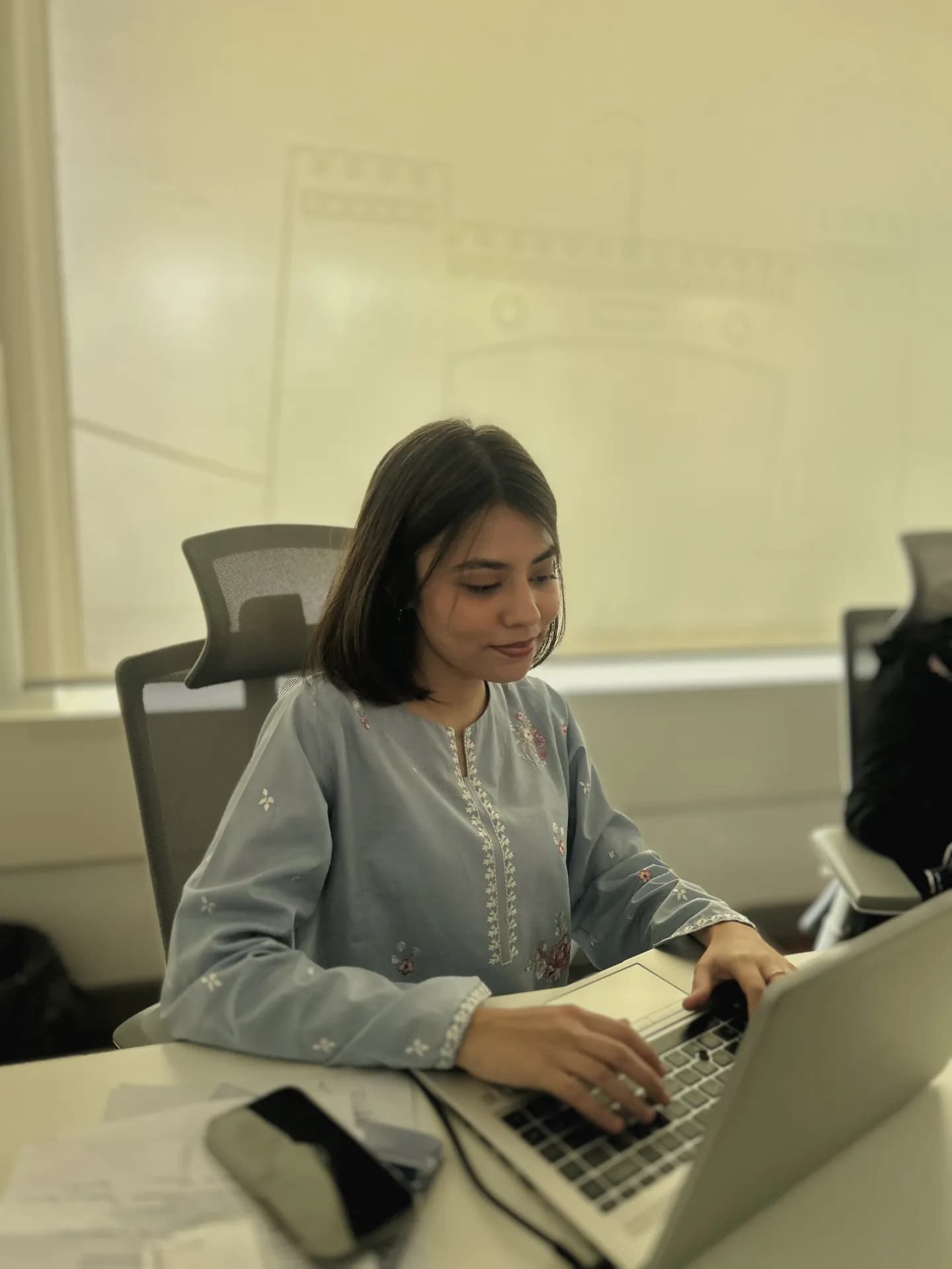 A Keenu team member focused at her workstation