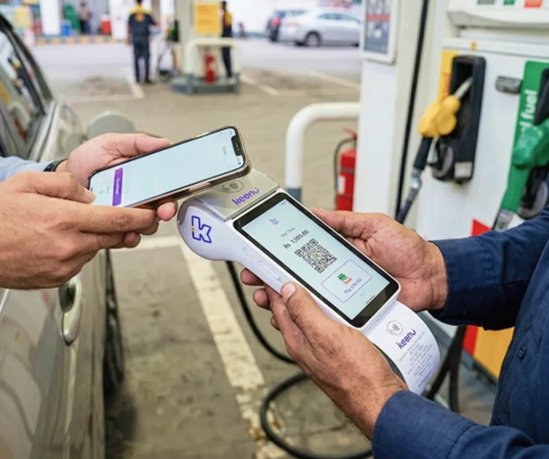 Phone scanning a Keenu QR code at a fuel pump for a fast contactless payment